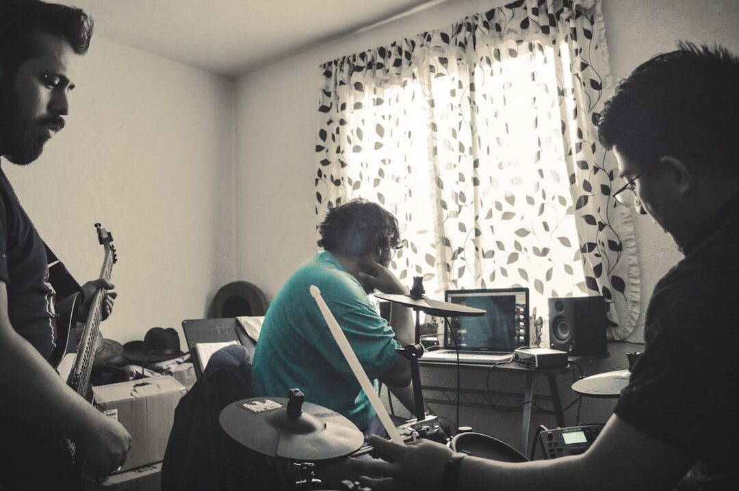 Small team of creators collaborating around a monitor in a studio